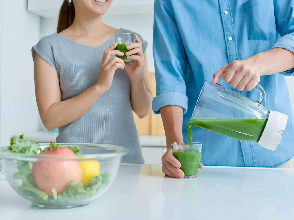 Image of a person enjoying a smoothie after blending.